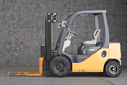 Forklift standing on industrial dirty concrete wall background