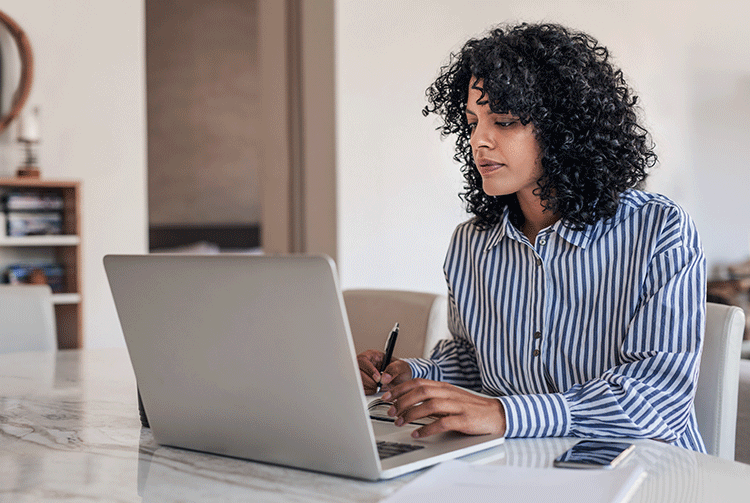 Woman working on a laptop at home
