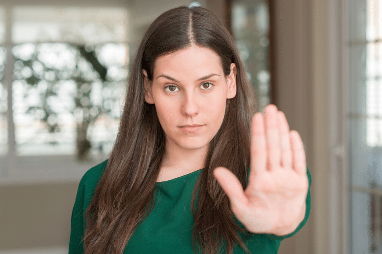 Woman holding her hand up to signal stop