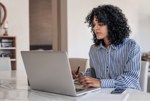 Woman working on a laptop at home