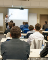 OSG instructor leading a JHSC refresher in-person class, pointing at the projector screen