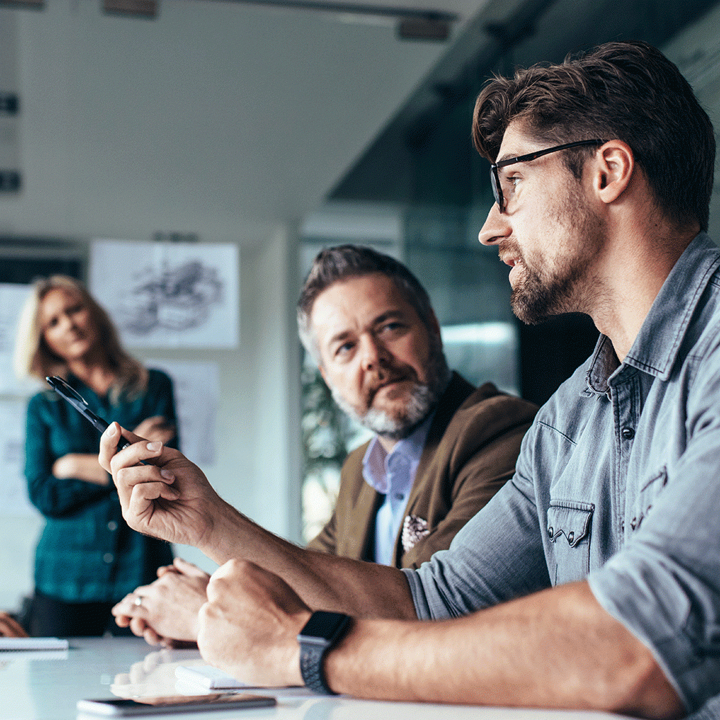 four people having a meeting around a table
